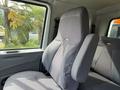 A gray fabric driver's seat from a 2011 International 4300 truck with a high back and side support