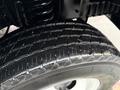 Close-up of a treaded tire on a 2017 Ford E450 showing detailed grooves and a shiny surface