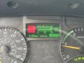 Dashboard display of a 2015 Mitsubishi Fuso FE160 showing average fuel consumption and odometer reading
