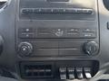 Dashboard controls of a 2015 Ford F-750 featuring knobs and buttons for air conditioning and auxiliary connections