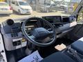 Interior view of a 2015 Mitsubishi Fuso FE showcasing the steering wheel dashboard and driver controls