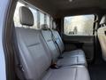 Interior view of the back seat of a 2020 Ford F-550 featuring grey leather upholstery and three seat cushions