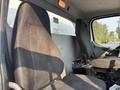 Two black cloth seats in the cabin of a 2016 Freightliner M2 106 truck positioned side by side