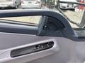 Interior door handle and controls of a 2015 Mitsubishi Fuso FE160 showing the armrest and window controls
