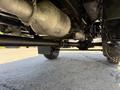 Undercarriage view of a 2009 International 3000 CE showing the exhaust system and rear axle components