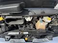 Close-up of the engine compartment of a 2017 RAM Promaster showing various components including a fluid reservoir battery and hoses