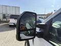A close-up view of the side mirror on a 2021 Ford F-150 showing the reflective surface and the twin mirror design
