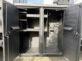 A 2012 International DuraStar 4300 vehicle with open doors revealing an organized storage compartment featuring shelves and hooks inside
