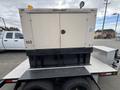 A beige Katolight SED60FPJ4 generator with a black base displayed on a trailer with a single yellow light on top