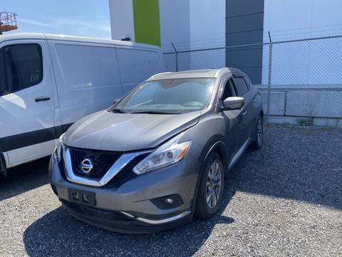 A gray 2017 Nissan Murano parked in an outdoor area with a sleek design featuring a prominent front grille and stylish headlights