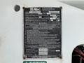 2006 International 4300 vehicle with an Altec Industries instruction and warning label attached to its side