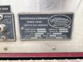 A metal identification plate attached to a 2002 GMC C7500 listing the Waterous Company name, model information, serial numbers, and specifications