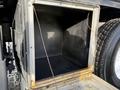 An empty rectangular storage compartment on a 2010 International 4300 truck with exposed wires inside