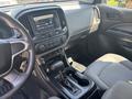 Interior of a 2017 Chevrolet Colorado featuring dashboard controls center console and steering wheel with gray upholstery on the seats