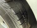 Close-up of a tire tread on a 2017 Ford Transit Connect showing clear grooves and water droplets on the surface