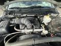 Engine compartment of a 2012 RAM 2500 showing the air intake system battery and various engine components