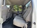 Interior view of a 2019 Ford F-550 showing the rear seats and passenger area with gray fabric upholstery and seatbelt fasteners