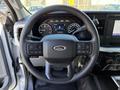 Steering wheel of a 2024 Ford F-550 with controls on both sides and the Ford logo in the center