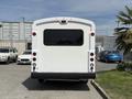 A white 2017 Chevrolet Express van parked with a large rear window and round lights positioned at the corners