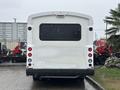 White 2018 Chevrolet Express van viewed from the rear with red brake lights and a large black window