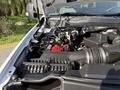 A close-up view of the engine compartment of a 2021 Ford F-250 SD showing the engine components battery and air intake system