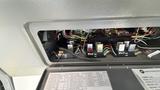 The interior fuse box of a 2021 Ford Transit showing various fuses and colorful wiring connections