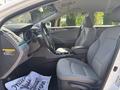 Interior view of a 2014 Hyundai Sonata featuring gray upholstery a steering wheel dashboard and front seats