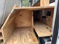 Interior view of a 2008 Ford F-250 SD showing wooden storage compartments built into the vehicle with plywood surfaces and a spacious layout