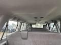 Interior view of a 2010 Ford Econoline showing the ceiling and rear seats with gray upholstery