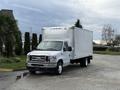 A white 2022 Ford E-450 box truck parked on a driveway