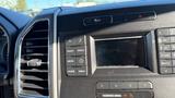Dashboard of a 2016 Ford F-150 featuring a radio display with controls for CD, radio, Sirius, phone, and menu options