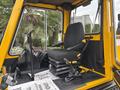 A black seat in the operator's cabin of a 2004 Bombardier SW48 with controls and levers positioned nearby
