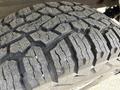 Close-up view of a rugged tire tread from a 2019 Chevrolet Silverado 1500 showing deep grooves and textured surface designed for off-road traction