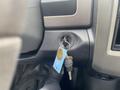 A close-up of the ignition key and key ring in a 2011 Dodge Ram 5500 dashboard with a focus on the key slot