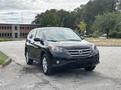 A 2014 Honda CR-V in black sleek design parked at an angle showcasing its front and side view with alloy wheels and distinctive grille