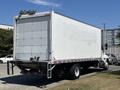 A 2020 Hino 338 truck with a large white cargo box and a visible rear door without any markings