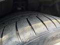 Close-up of a worn tire from a 2004 BMW 6-Series showing tread patterns and a partially visible sidewall