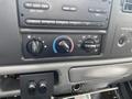 Dashboard controls of a 2003 Ford F-450 SD featuring dials for air conditioning and heating settings along with switches for different functions