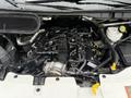 The engine compartment of a 2023 Ford Transit showing various components including the air intake manifold and fluid reservoirs