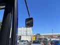 A side mirror of a 2018 Grande West Vicinity bus reflecting part of the surrounding area