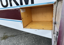 An open storage compartment of a 1986 Sorrell Hiperbipe SNS-7 amateur-built aircraft with wooden interior and no contents visible