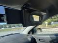 A 2006 Pontiac G6 features a sun visor with a flip-down mirror and an additional screen folded up near the windshield