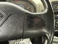 Close-up of the steering wheel and dashboard of a 2013 International Workstar 7500 showing the dashboard controls and gauges