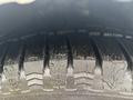 Close-up of a tire with deep treads showing significant wear and grooves on a 2019 Ford Transit Connect