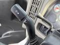 A close-up of the turn signal lever in a 2010 International 4300 showing markings for various signal functions
