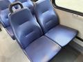 Two blue upholstered seats designed for passenger transport in a vehicle