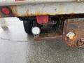 A 2011 Dodge Ram 5500 with a rusty rear bumper and a round LED light mounted on the side
