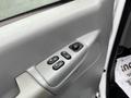 Interior door panel of a 2006 Ford Econoline featuring window controls and locking buttons