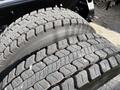 Close-up of two large, rugged tires showing deep treads and a robust construction designed for heavy-duty vehicles