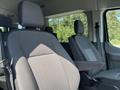 Interior view of a 2025 Ford Transit T-350 showcasing two front seats with fabric upholstery and armrests